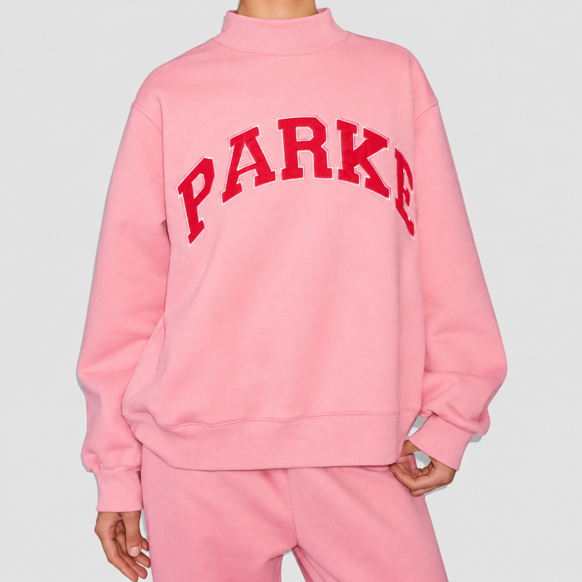 Marguerite | Women’s Oversized Mock-Neck Varsity Sweatshirt — Pink-red letter
