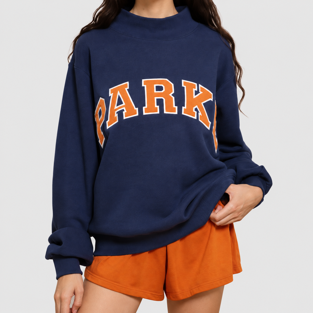 Marguerite | Women’s Oversized Mock-Neck Varsity Sweatshirt — Navy blue-orange characters